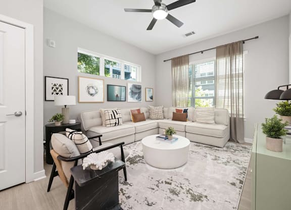 A living room with a white couch and a coffee table.