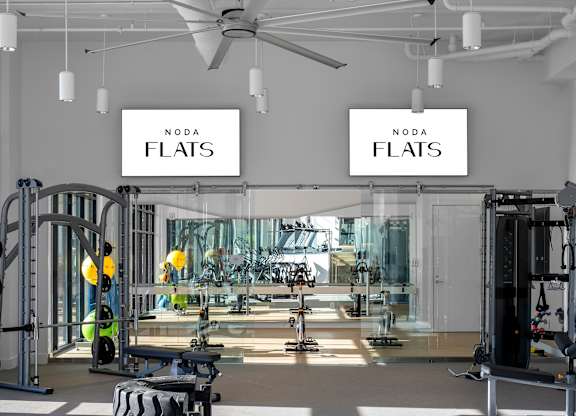 A gym with a sign that says NODA FLATS.
