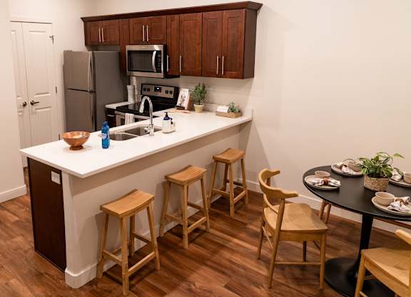 Four Seasons Logan Apartments and Townhomes Seating at Kitchen Bar