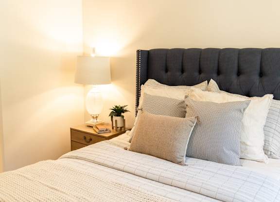 Four Seasons Logan Apartments and Townhomes Bed with Fluffy Comforter