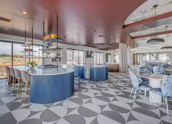 A modern dining room with a blue and white checkered floor.