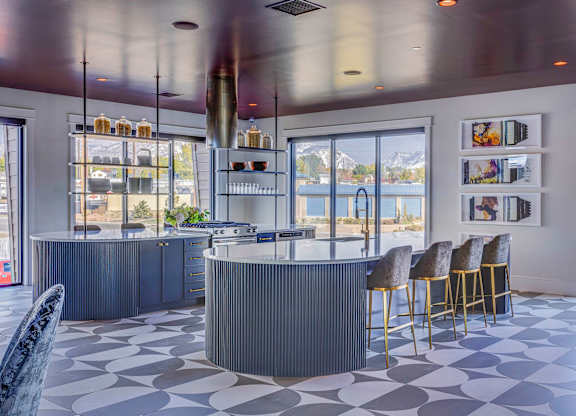 A modern bar with a curved counter and a row of stools.