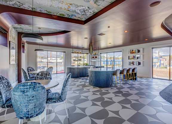 A modern dining room with a large table and chairs.