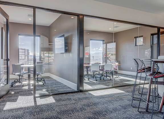 A conference room with glass walls and a carpeted floor.