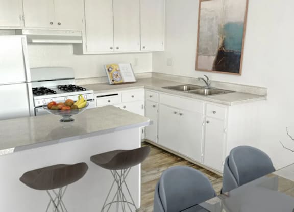 A kitchen with white cabinets and a white fridge.