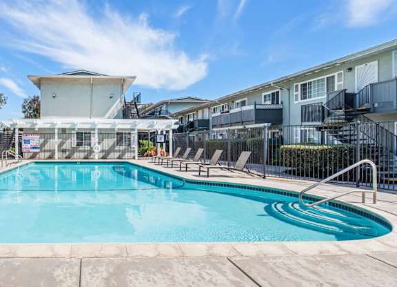 A swimming pool surrounded by apartment buildings.