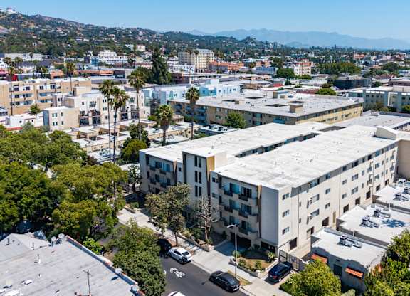 A large white building with a parking lot in front of it.