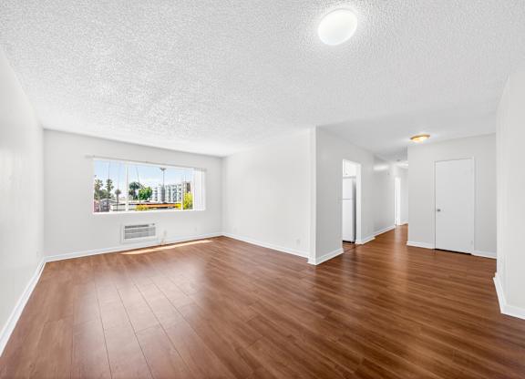 A room with wooden floors and white walls.