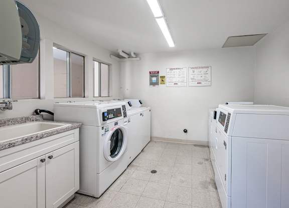 A laundry room with a washer and dryer at Oak Park Apartments, Monrovia, 91016