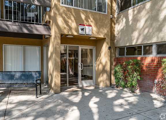 A building with a bench in front of it at Oak Park Apartments, Monrovia, 91016