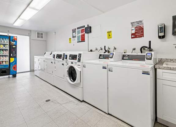 A row of washing machines in a laundromat.