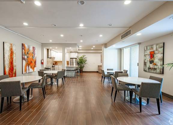 A dining room with a long table and chairs at Oak Park Apartments, Monrovia, 91016