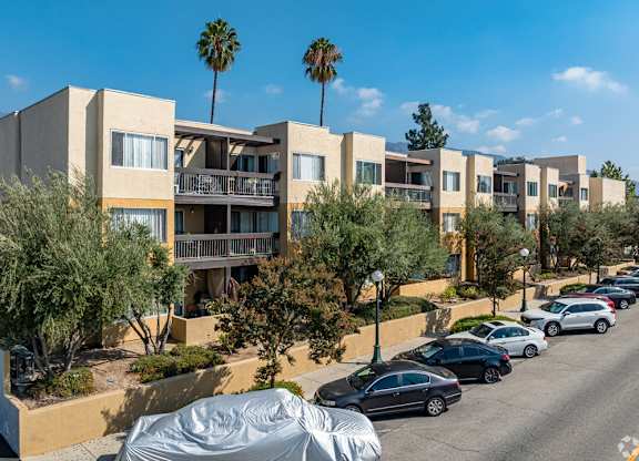 A row of modern houses with cars parked in front at Oak Park Apartments, Monrovia, 91016