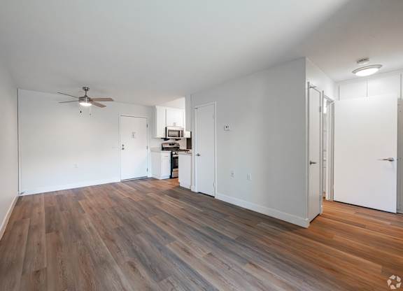 A room with a ceiling fan and wooden flooring at Oak Park Apartments, Monrovia, 91016