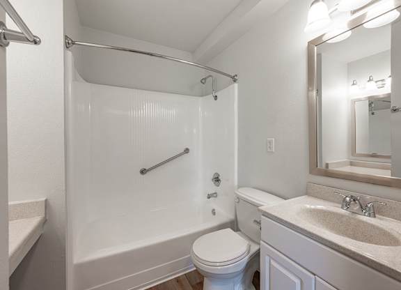A white bathroom with a toilet, sink, and shower at Oak Park Apartments, Monrovia, 91016