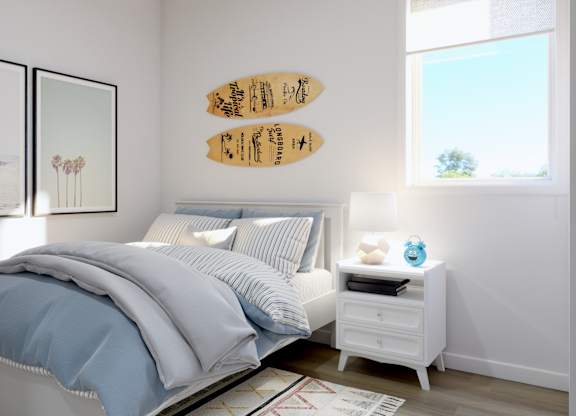 A bedroom with a bed, nightstand, and two framed pictures on the wall.