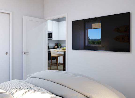 A bedroom with a bed, two doors, and a window.