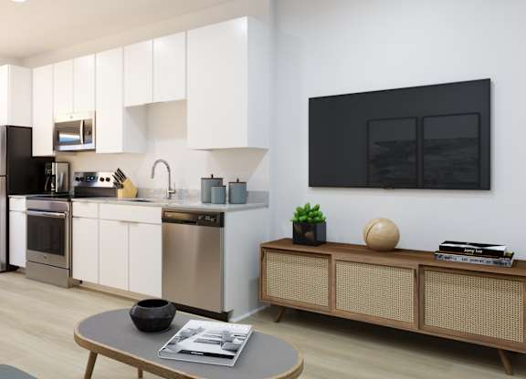 A modern kitchen with stainless steel appliances and white cabinets.