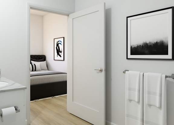 A bathroom with a towel rack and a picture on the wall.
