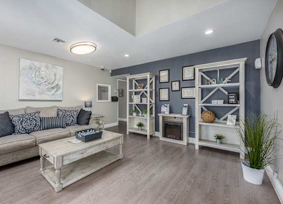 A living room with a grey couch and a wooden coffee table.
