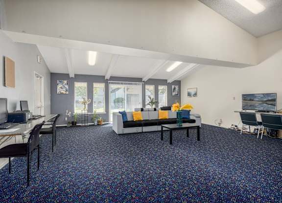 A room with a blue carpet and a white ceiling.