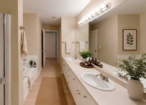 A bathroom with a white sink and a mirror.