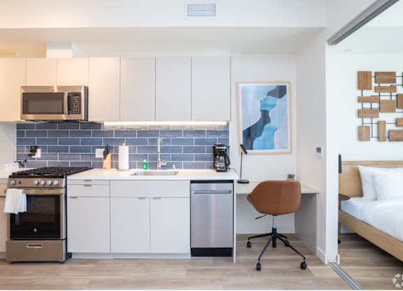 a kitchenette and a bed in a 555 waverly unit