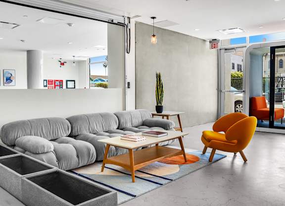 a living room with gray couches and a coffee table