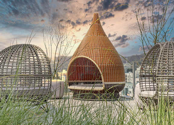 a building with a pointed roof made out of wicker