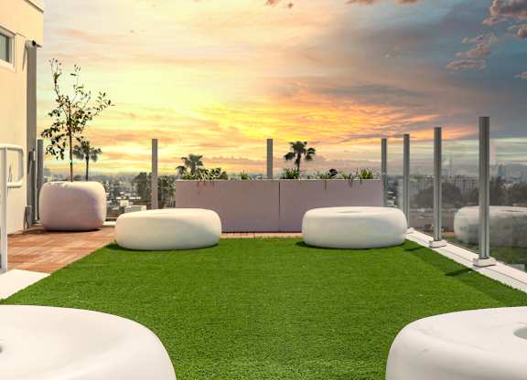 a rendering of a rooftop garden with grass and a sunset in the background