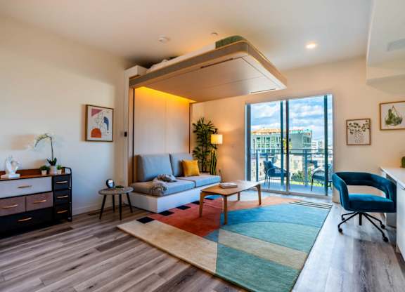 a living room with a couch and a balcony