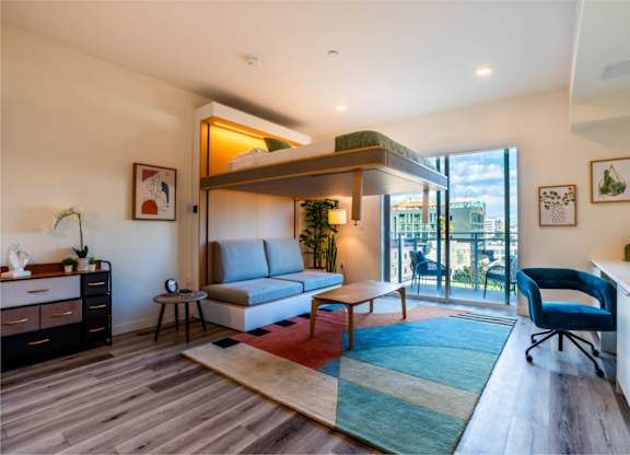 a living room with a couch and a balcony