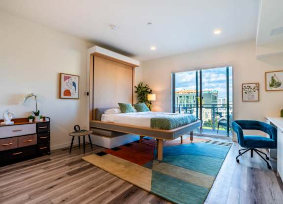a bedroom with a bed and a balcony