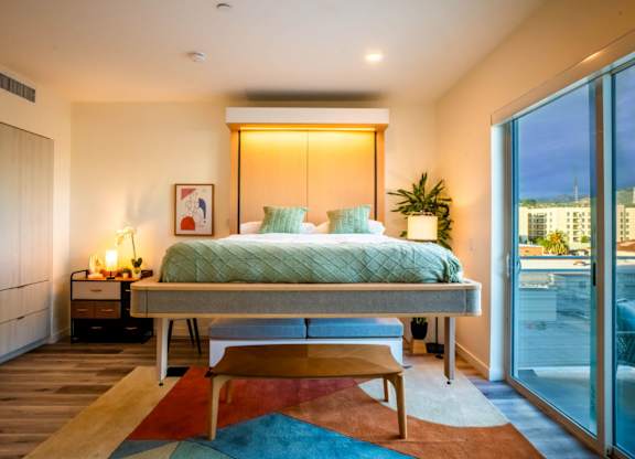 a bedroom with a bed and a sliding glass door