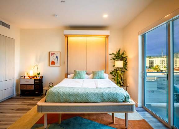 a bedroom with a bed and a sliding glass door