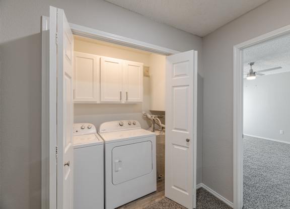 A small laundry room with a washer and dryer.