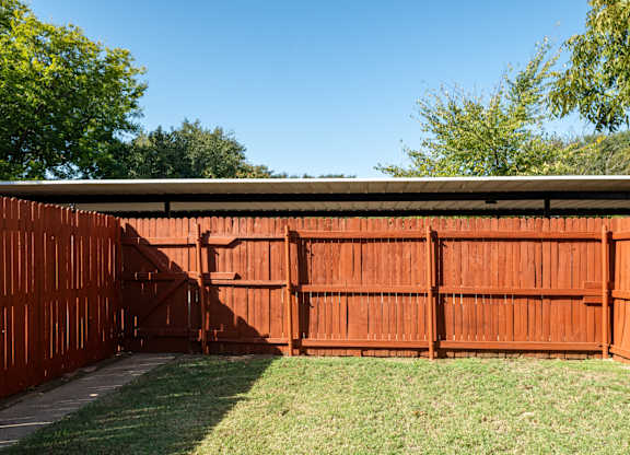 A brown fence with a gate in the middle.