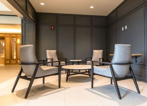 a room with four chairs and a coffee table