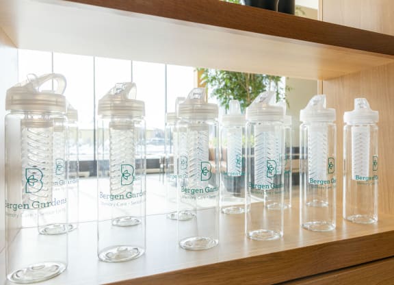 a row of water bottles on a shelf