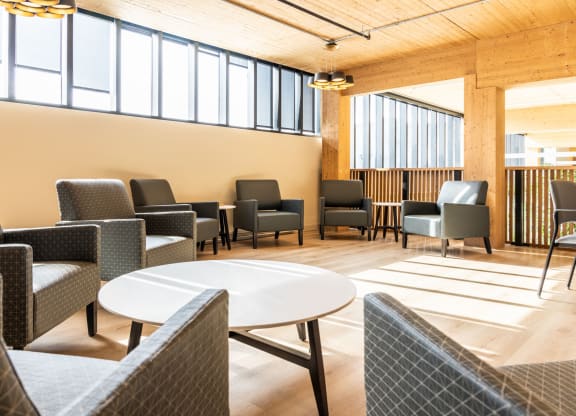 a lounge area with chairs and tables
