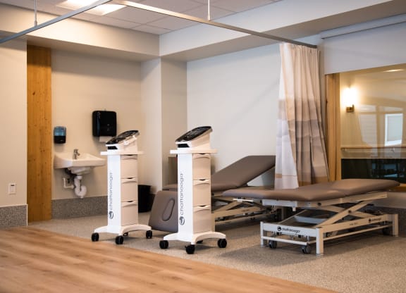 a hospital room with two stretcher beds and a sink