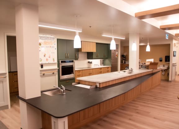 a large kitchen with a long island with a sink and a stove