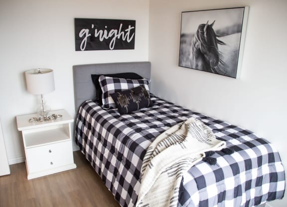 a bedroom with a bed and a nightstand