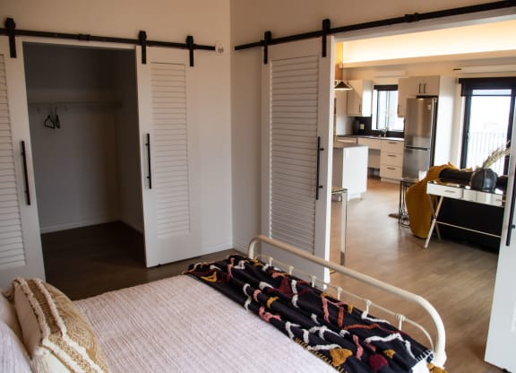 a bedroom with a bed and a desk in a room