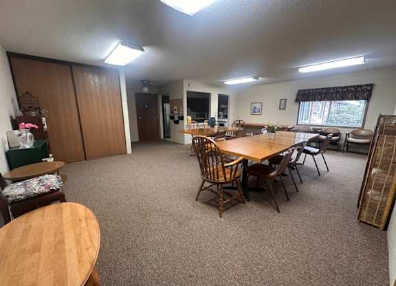 A room with a table and chairs in it.