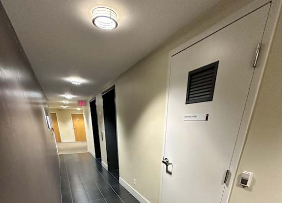 A long hallway with a door on the right.