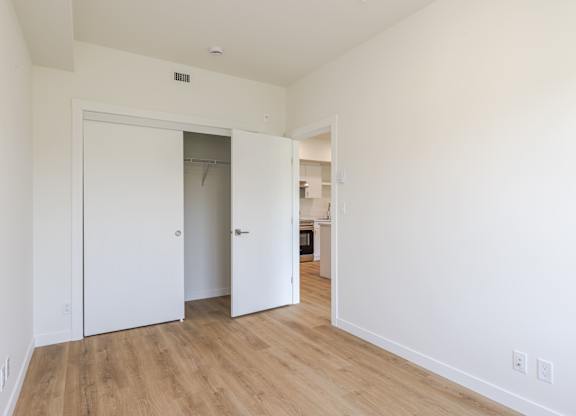 A room with a white door and a white wall.