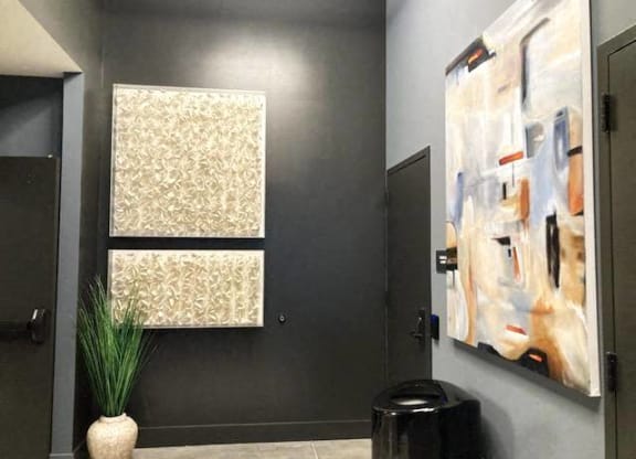 a bathroom with two paintings on the wall