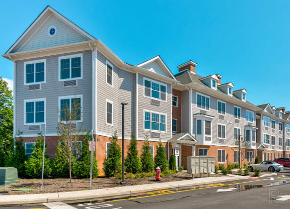 a row of apartment buildings on a city street  at Solo at North Bergen, North Bergen, NJ