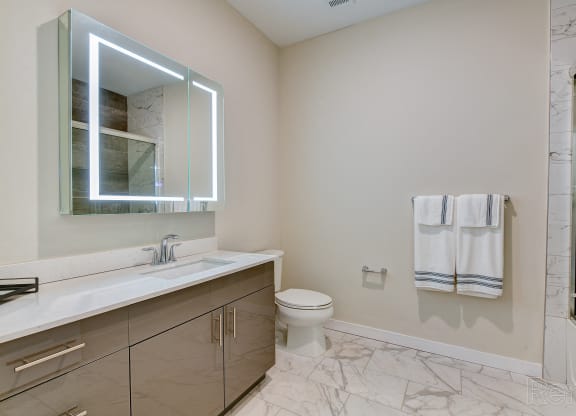 a bathroom with a mirror and a sink and a toilet at Solo at North Bergen, New Jersey